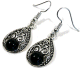 Boucles d'oreilles pendantes en metal argente cisele serties de pierres noir